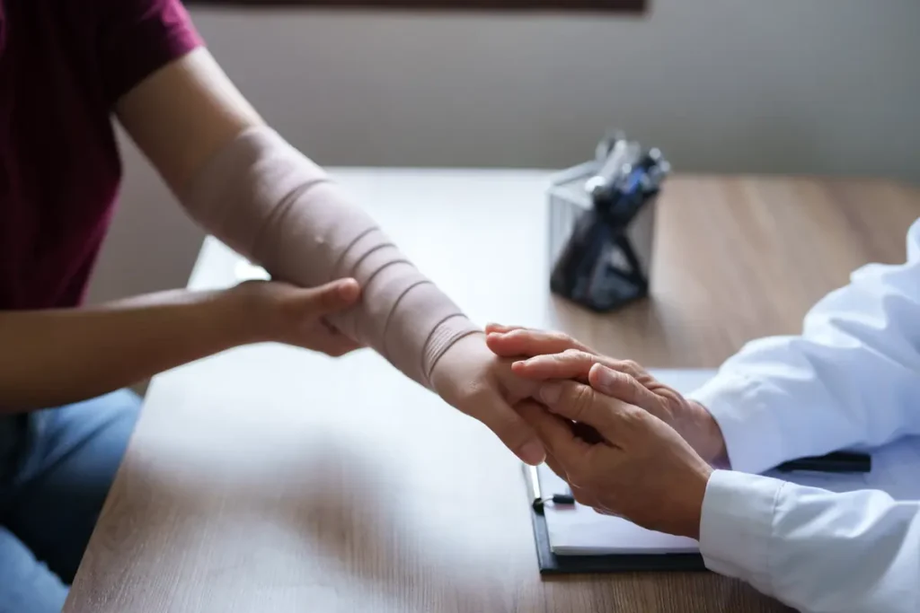 Doctor examines a patient's bandaged arm