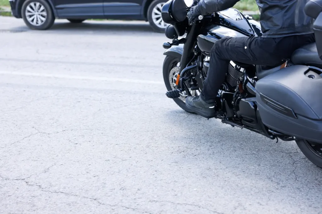 Rider on a black cruiser motorcycle in traffic