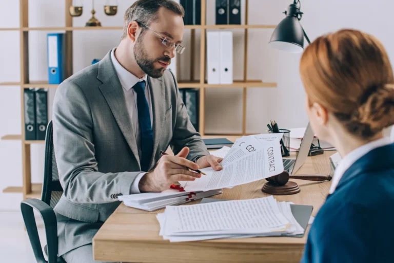 Lawyer goes over documents with a family member at his desk