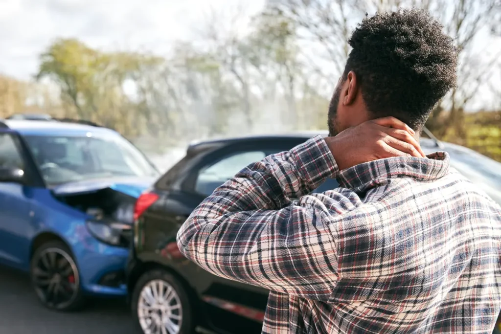 Man holds his neck after a car crash