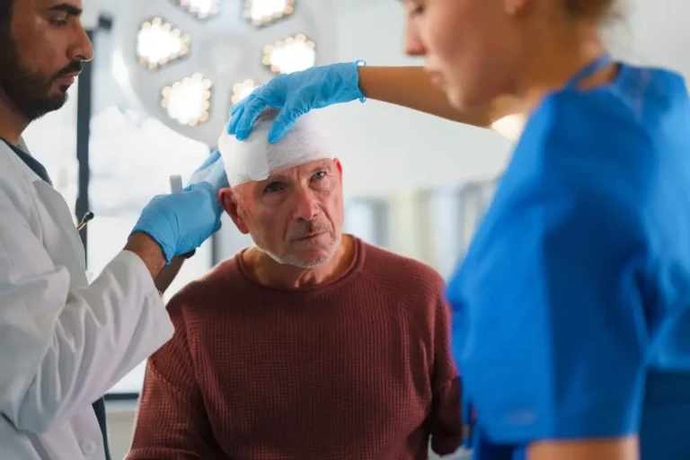 Older man receives medical attention for a head injury