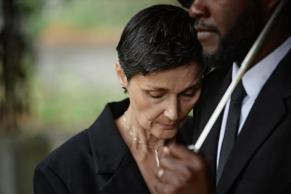 Grieving couple dressed in black