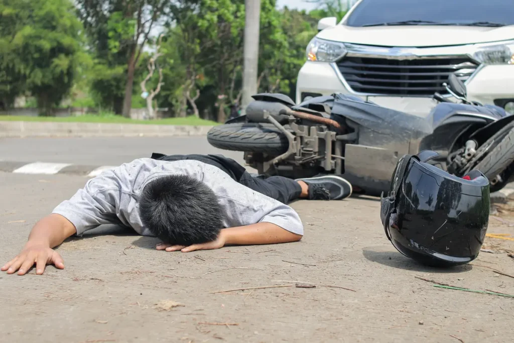 Motorcycle rider lying on the street after a crash