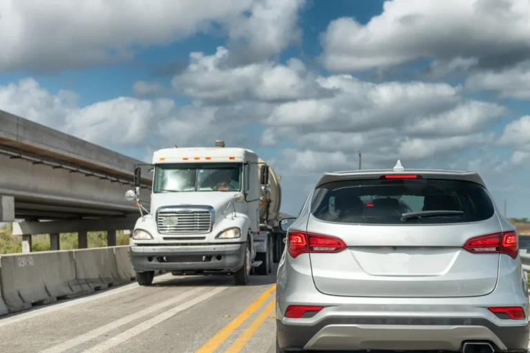Semi truck and an SUV side by side on a busy highway