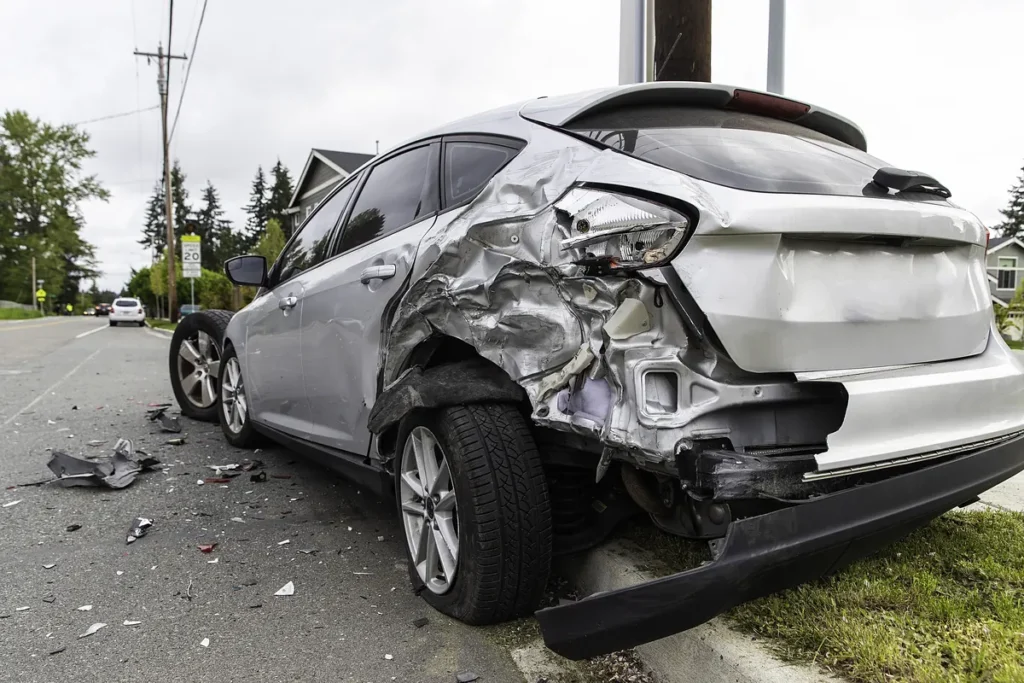 Silver car with a crushed rear corner after a crash