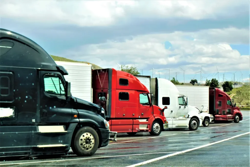 Semi-trucks parked in a row at a truck stop