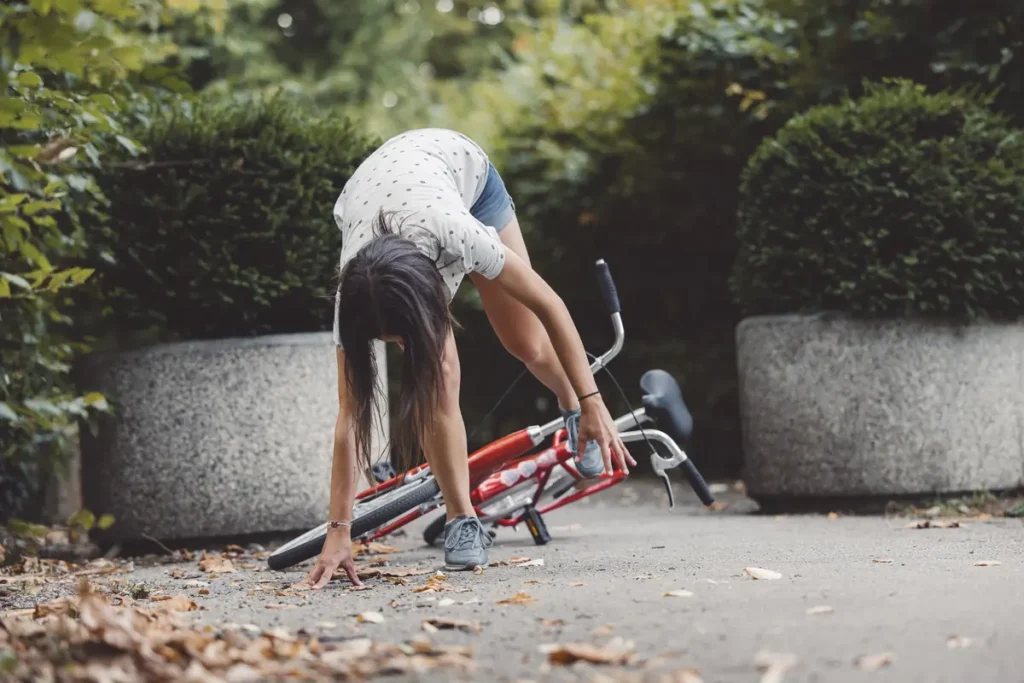 Woman checks her leg after a bike fall