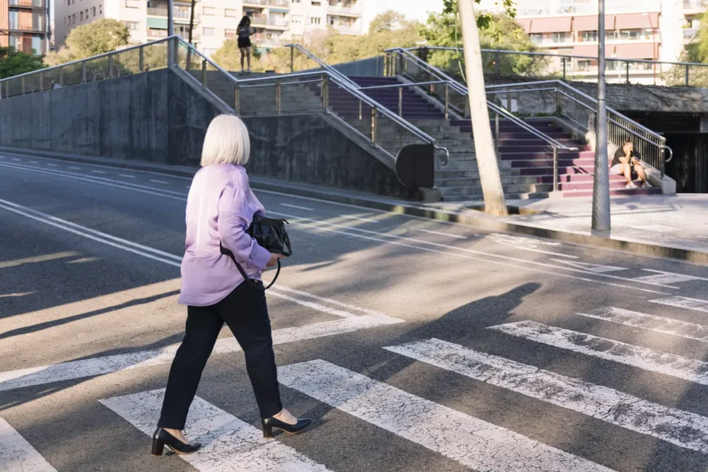 Woman crossing a city street in a crosswalk