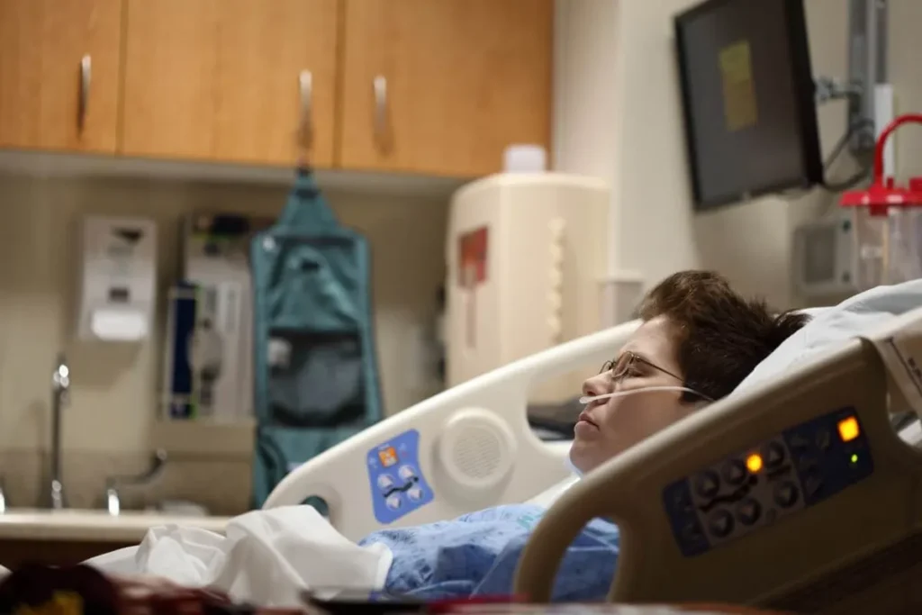 Injured patient resting in a hospital bed